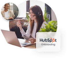 The image shows a woman conducting a HubSpot onboarding session with a customer over the phone.